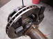 1989 Ford Bronco - Close-up view of a brake rotor and caliper assembly attached to an axle tube, with a timestamp visible in the corner.