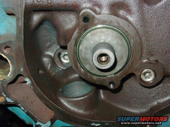 Close-up of an engine block with a circular component attached