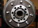 1989 Ford Bronco - Close-up view of a vehicle's wheel hub and brake rotor assembly, revealing internal components and grease.