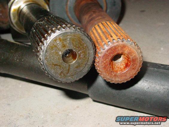 Close-up of two splined shafts, one showing rust and wear, the other appearing greased