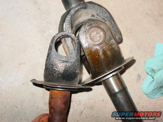 close-up of two driveshaft u-joints, one looks worn