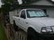1993 Ford Bronco - White Ford Ranger pickup truck parked in a driveway, seen from a 3/4 front angle.