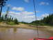 1989 Ford Bronco - View from inside a red vehicle, looking out at a muddy off-road course with several other vehicles visible in the distance.