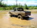 1989 Ford Bronco - This classic Ford Bronco navigates a muddy obstacle on a sunny day.