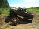 1989 Ford Bronco - A driver navigates a lifted Ford Bronco through a muddy, wooded terrain.