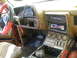1989 Ford Bronco - The interior of a vehicle is heavily covered in mud, suggesting recent off-road use.