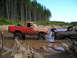 1989 Ford Bronco - Two trucks are stuck in the mud during an off-road excursion.