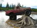 1989 Ford Bronco - This heavily modified pickup truck navigates a challenging off-road course, getting covered in mud.