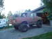 1989 Ford Bronco - Modified 1989 Ford Bronco parked in gravel driveway outside a garage.