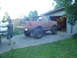 1989 Ford Bronco - A heavily modified Ford Bronco sits outside a garage, ready for off-road adventures.