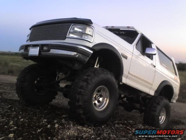 White 1995 Ford Bronco with large tires and lifted suspension