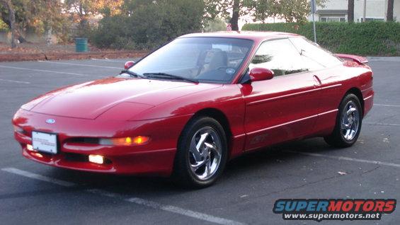 Red 1996 Ford Probe parked in a lot, front 3/4 view
