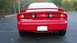 1996 Ford Probe - Rear view of a red 1996 Ford Probe with a spoiler and dual exhaust pipes.