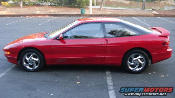 Red 1996 Ford Probe GT coupe parked in a lot, side view