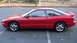 1996 Ford Probe - A red 1996 Ford Probe GT coupe is shown from the side in a parking lot.