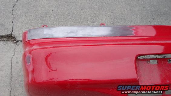 Shaving the badges off the back bumper.