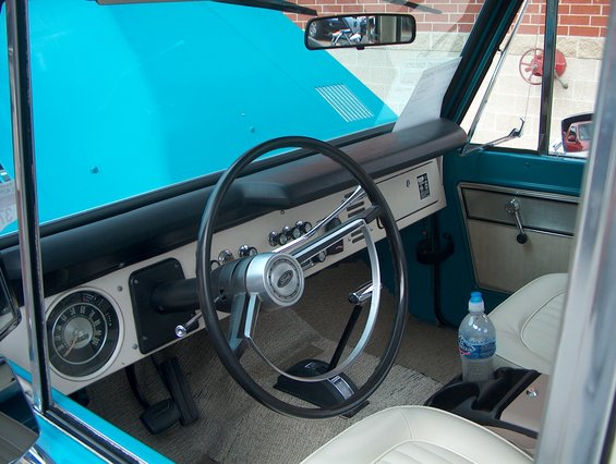 1978 Ford Bronco interior with turquoise dashboard and white seats