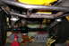 1988 Ford Bronco - Close-up of the undercarriage, focusing on suspension and drivetrain parts, with custom frame work visible.