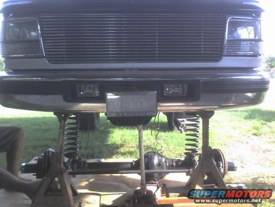 1995 Ford Bronco front end lifted for suspension work, license plate reads D-ROCK