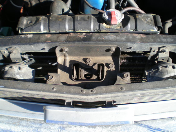Close-up of a car's front end, showing the radiator, grille support, and part of the bumper