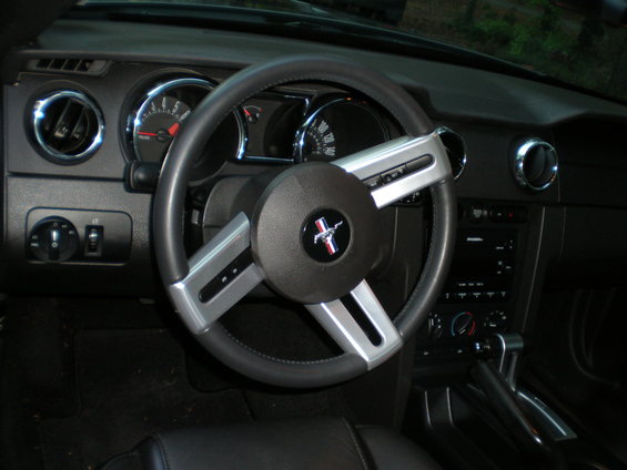 Interior view of a Ford Mustang with a prominent steering wheel and dashboard