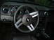 1966 Ford Mustang - The interior of a Ford Mustang, its steering wheel, dashboard, and center console.