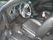1966 Ford Mustang - Interior view of a car's driver side, including the seat, steering wheel, and dashboard.