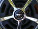1966 Ford Mustang - Close-up of a 1966 Ford Mustang wheel, showing the iconic running horse emblem.