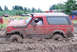 1989 Ford Bronco - A red 1989 Ford Bronco navigates a mud bog during an event.