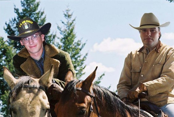 Two guys in cowboy hats on horses, one wearing a U.S. Air Force hat