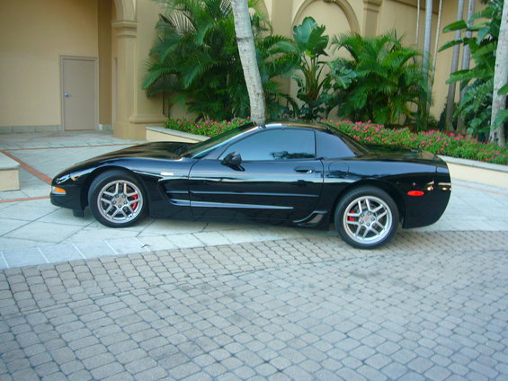 Black Chevrolet Corvette C5 coupe parked on a paved driveway