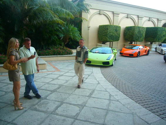 Lime green Lamborghini Gallardo parked next to an orange Lamborghini