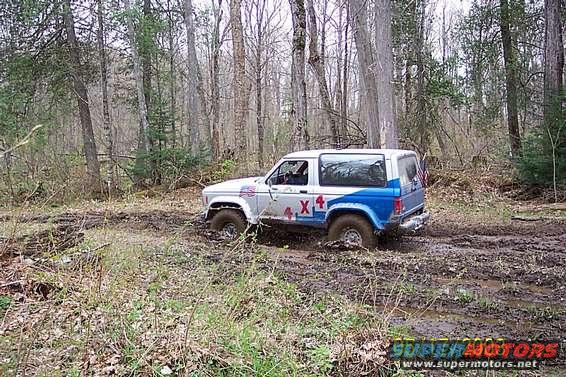 Ford Bronco II stuck in mud with 4x4 decals on the side