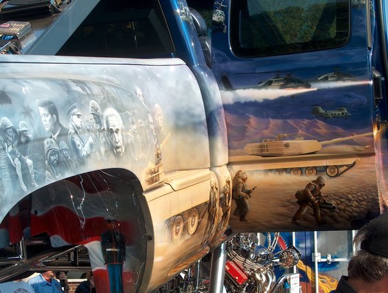 Side view of a truck with custom airbrush art depicting historical figures and military scenes