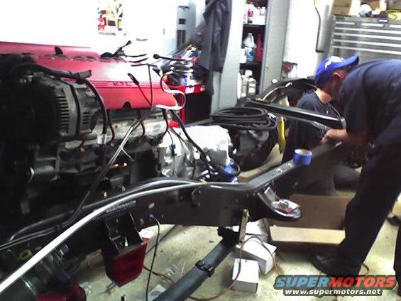 Engine and chassis components being worked on in a garage setting