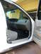 2001 Ford Crown Victoria - The interior of a white 2001 Ford Crown Victoria is visible with the driver's side door open.