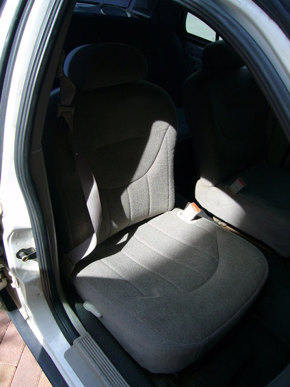Interior view of gray cloth seats and seatbelts
