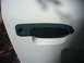 2001 Ford Crown Victoria - Exterior door handle assembly on a white vehicle.
