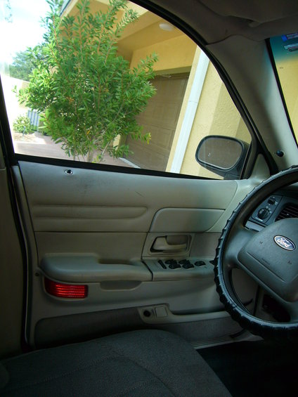 Interior view of a 2001 Ford Crown Victoria showing door panel and steering wheel