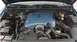 1998 Ford Crown Victoria - The engine bay of a 1998 Ford Crown Victoria, a blue engine cover and prominent alternator.