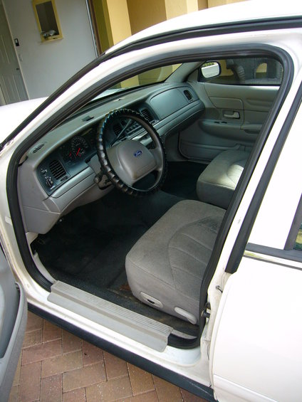 Interior of a 2001 Ford Crown Victoria, showing the dashboard, steering wheel, and front seats