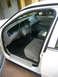 2001 Ford Crown Victoria - The interior of a white Ford Crown Victoria, viewed from the passenger side door.