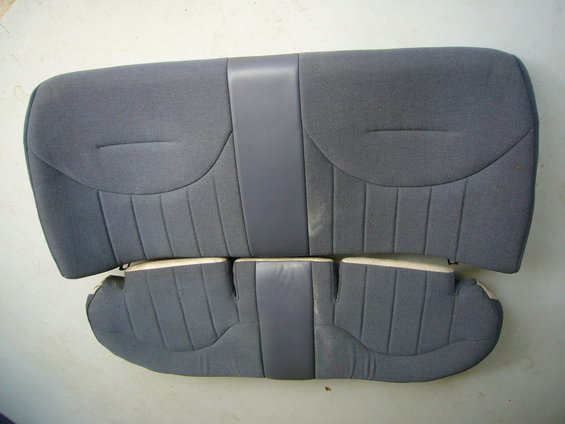Gray fabric car seat upholstery with vertical stitching and a central gray vinyl strip