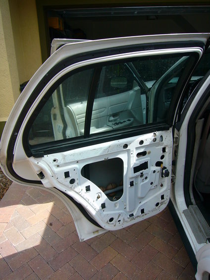 2001 Ford Crown Victoria rear door interior with panel removed, showing internal mechanisms