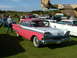 1988 Ford Sport - Two-tone 1959 Ford Fairlane 500 at an outdoor car show, with a plane and other vehicles present.