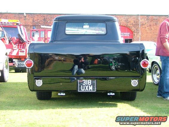 Black pickup truck rear view, round taillights, license plate 318 UXM
