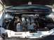 1999 Ford Taurus - The engine bay of a 1999 Ford Taurus is visible, showing the engine and various components.