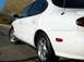 1999 Ford Taurus - This white 1999 Ford Taurus is captured from a 3/4 front angle, highlighting its side and rear quarter panel.