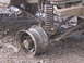 1989 Ford Bronco - The vehicle's wheel is deep in mud, showing the suspension system and the muddy terrain.
