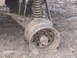 1989 Ford Bronco - A vehicle's wheel and suspension are submerged in thick mud, indicating it is stuck.